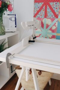 The machine quilter frame clamped to the table